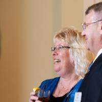 Two guests at the Sarasota event smiling.